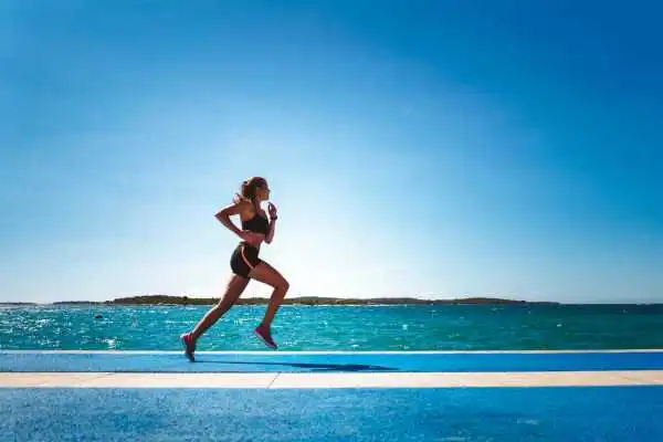 Woman running showing strong leg muscle Sheffield